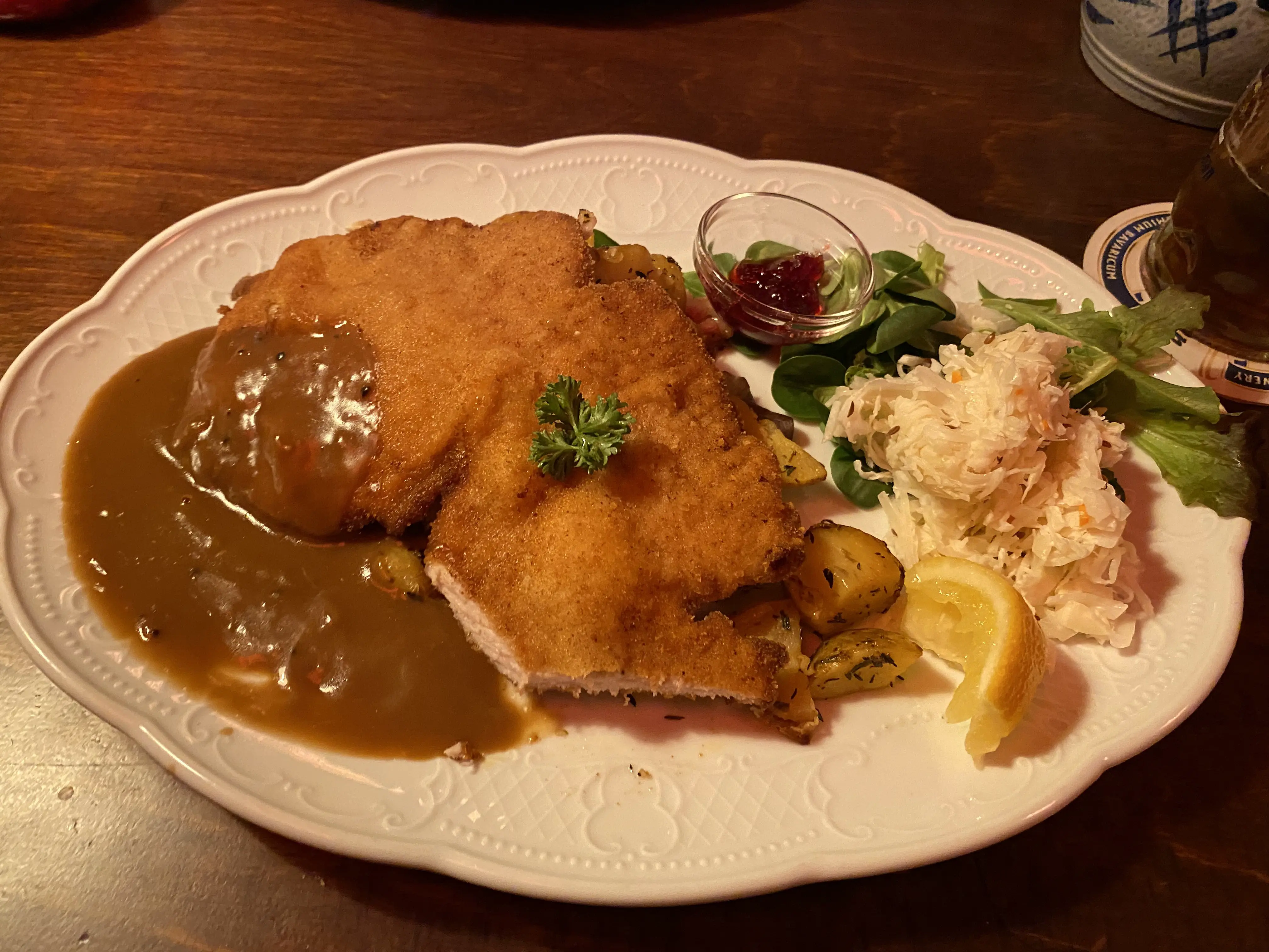 A picture of the food at the restaurant, a schnitzel with potatoes and salad