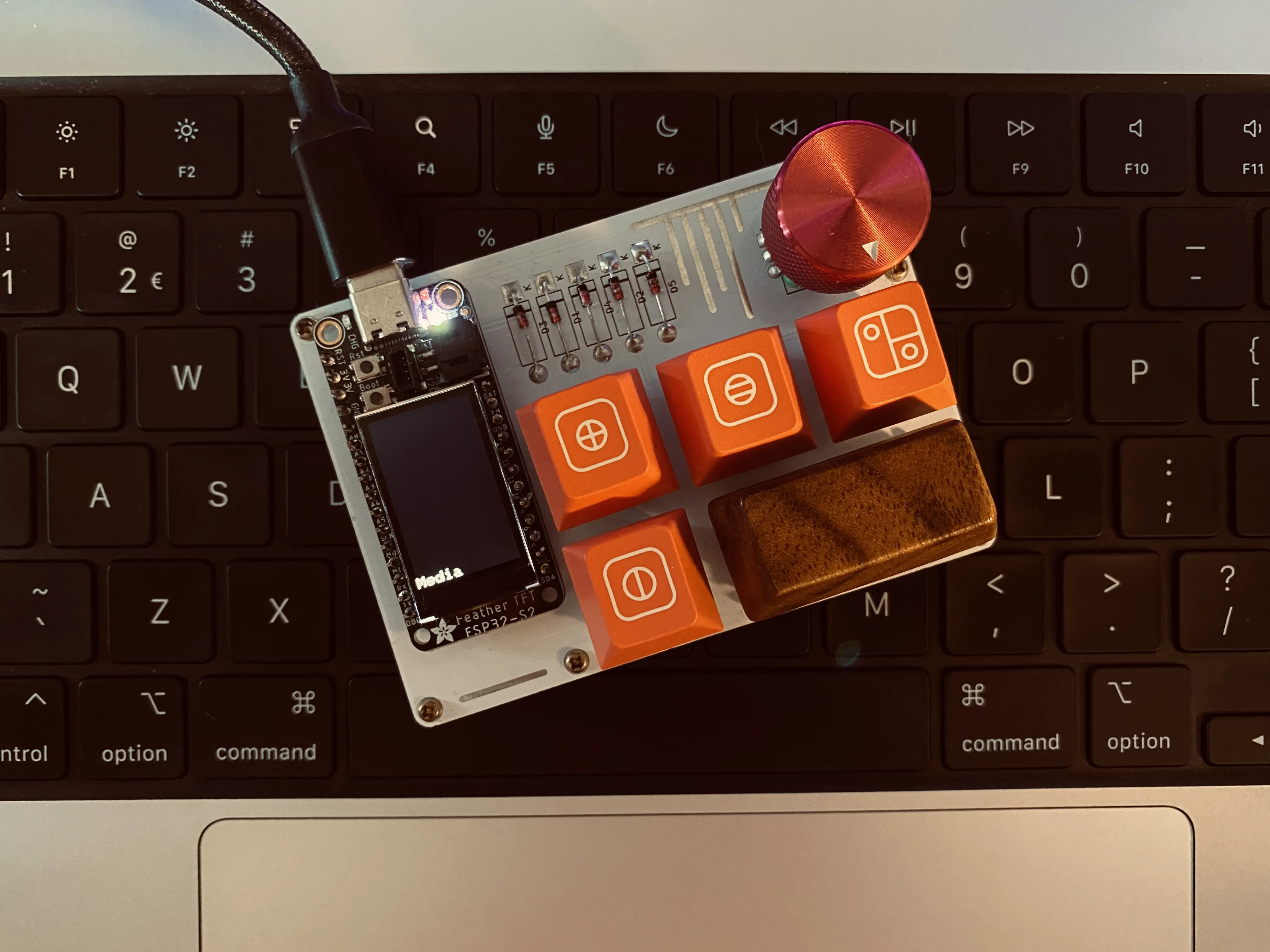 Image of a small macropad with 6 buttons, a display and a rotary encoder