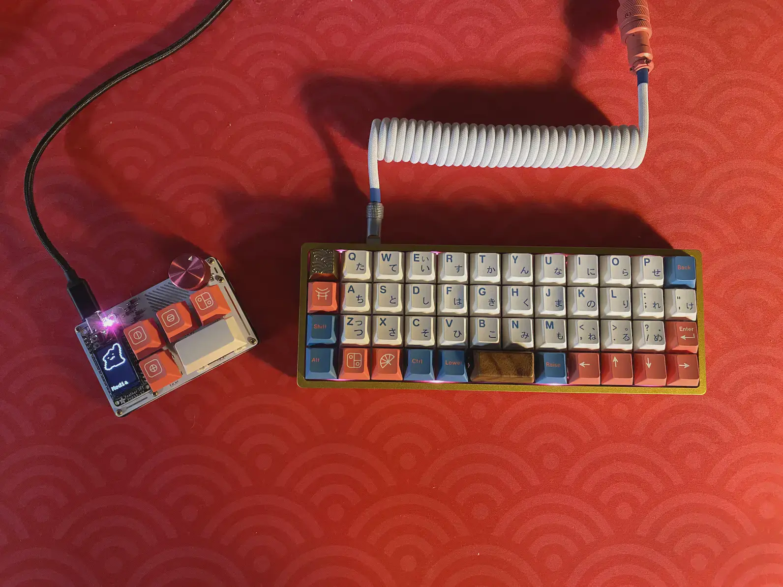 an olkb planck keyboard using a gmk bentō keycap set alongside a small custom macropad
